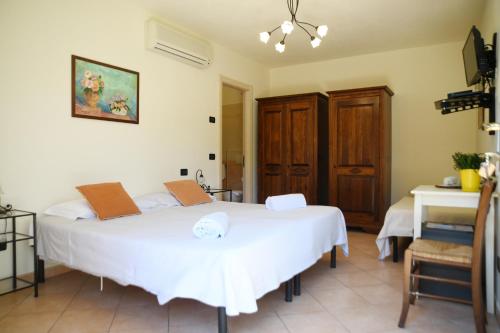 a bedroom with two beds and a desk in a room at Villa Gaia in Portoferraio
