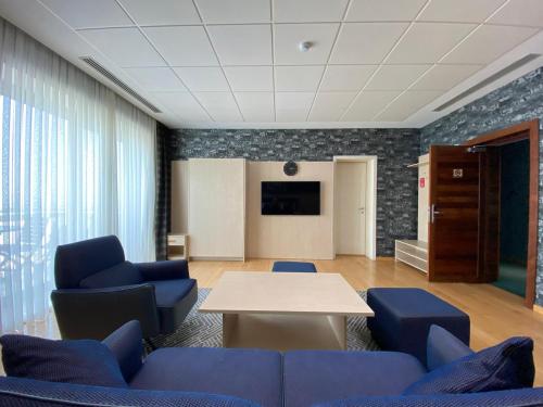 a meeting room with blue chairs and a table at Badam d'Art Boutique Hotel in Baku