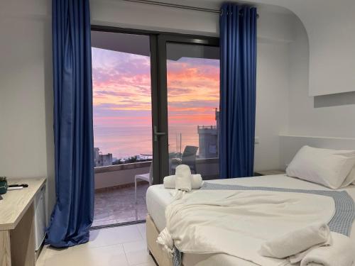 a bedroom with a bed and a window with a view at Sea View Hotel in Sarandë