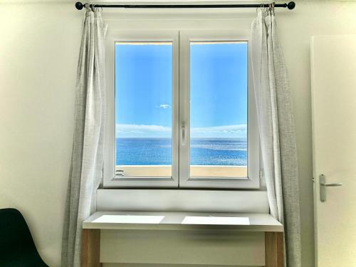 a window with a view of the ocean at Residence Canella in Sari Solenzara