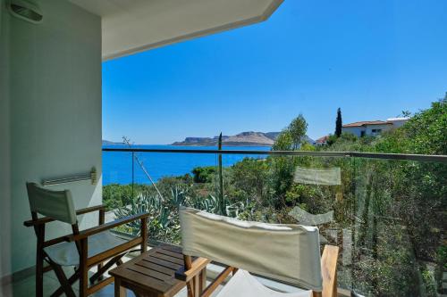 a balcony with two chairs and a view of the ocean at Aquarius Hotel in Kas