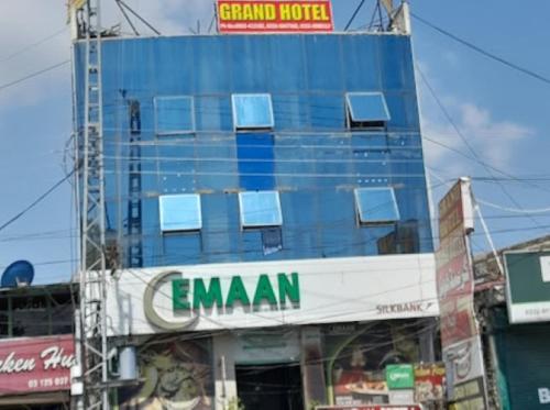a tall blue building with windows on top of it at Deen Resort Motel in Mānsehra