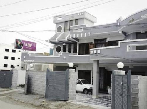 a building with a car parked in front of it at Deen Resort Motel in Mānsehra