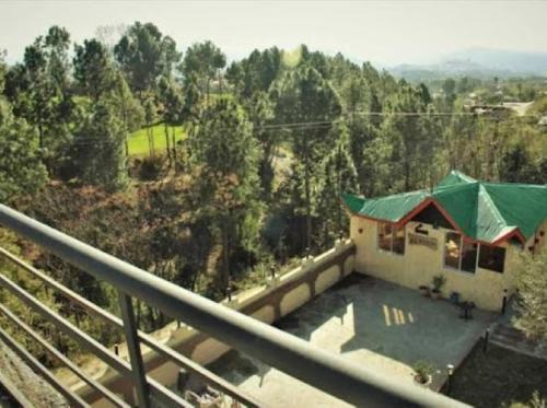 a view of a house with a swimming pool at Deen Resort Motel in Mānsehra