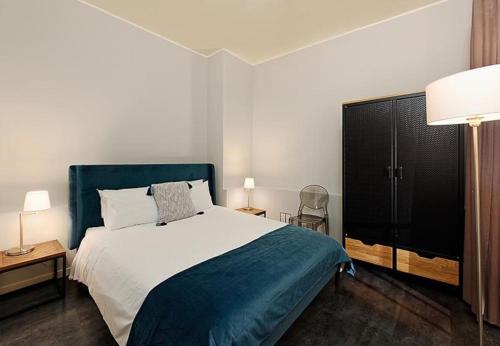 une chambre avec un grand lit avec une tête de lit bleue dans l'établissement #18 Rossetti Suite 2 Bedrooms , Central Old Nice/AC, à Nice
