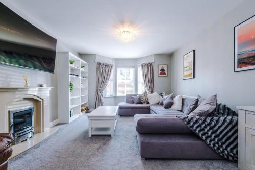 a living room with two couches and a fireplace at 5 bed Luxury Retreat with Spacious Living Spaces in Christleton