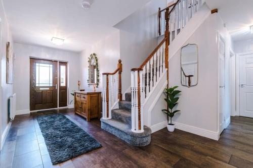 a home with a staircase and aoyer with white walls at 5 bed Luxury Retreat with Spacious Living Spaces in Christleton