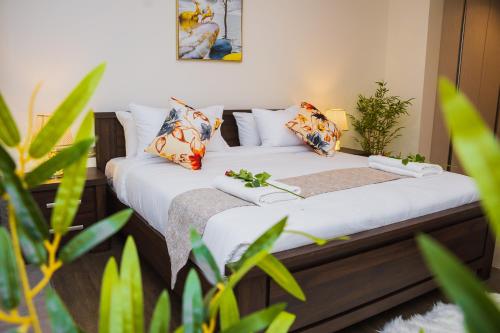 two beds in a room with plants at Capital M 2 Bedrooms Apartment- Deluxe Executive Rooms by BednBeyond Westlands Nairobi O72195O319 in Nairobi