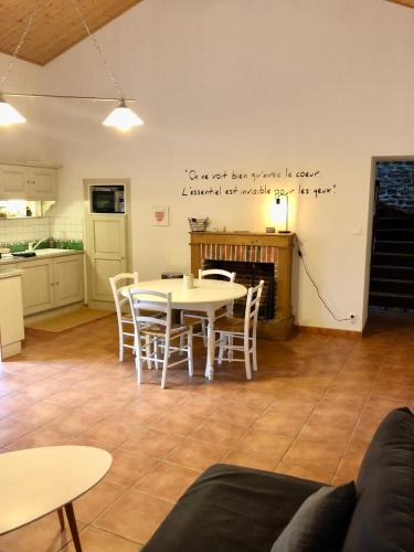 une pièce avec une table et des chaises et une cuisine dans l'établissement Maison de village au coeur de Talmont St Hilaire, à Talmont-Saint-Hilaire