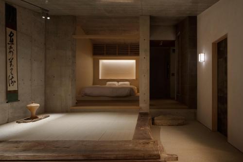 a bedroom with a bed with a window in it at Kamohan in Kyoto