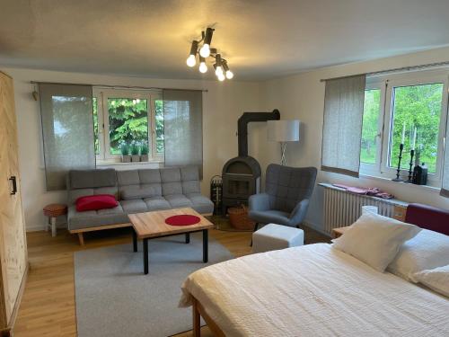 a living room with a bed and a couch and a table at Ferienwohnungen Mews in Immenstadt im Allgäu