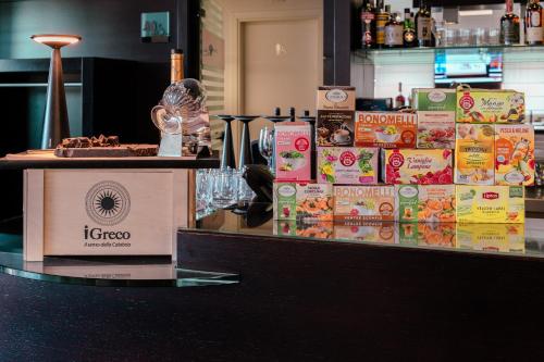 a counter with boxes of food on top of it at Ariha Hotel Cosenza in Cosenza