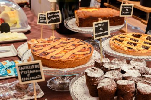 a display of pies and pastries on a table at Ariha Hotel Cosenza in Cosenza