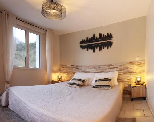 une chambre avec un lit avec deux oreillers dessus dans l'établissement Naou Costes, Modernité et Confort au cœur des montagnes, à Luz-Saint-Sauveur