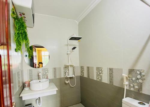 a bathroom with a sink and a mirror at Su Homestay in Cao Bằng