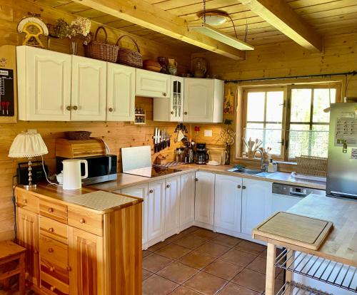 a kitchen with white cabinets and a counter top at Sznureczki in Przewóz