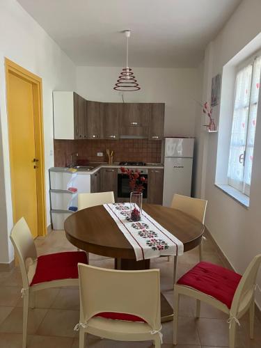 a kitchen with a dining room table and chairs at Casa vacanze Alfano in Ascea