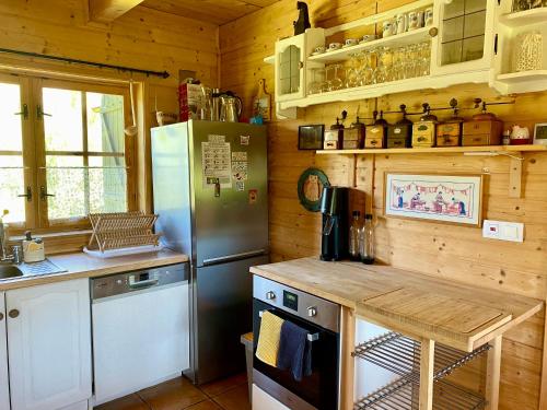 a kitchen with a refrigerator and a table in it at Sznureczki in Przewóz