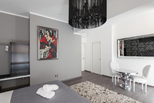 a bedroom with a table and a dining room at Town House Roma in Rome