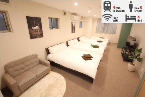 a living room with a couch and a chair at LUANAHOTEL IN KOUENJI in Tokyo