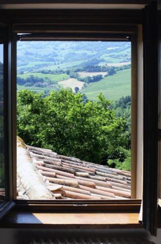 a window in a building looking out at a view at Country House Ca' Vernaccia in Urbino