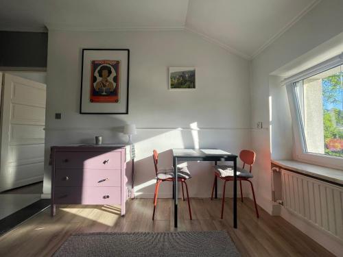 a room with a desk and a table and chairs at Studio Saska Kępa in Warsaw