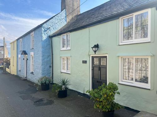 a row of green and blue houses on a street at Bwthyn Bryn Gwyn in Beaumaris