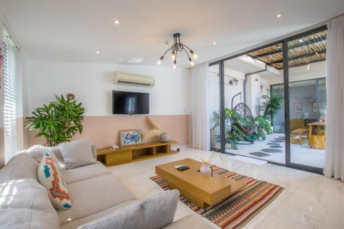 a living room with a couch and a table at Sanayen Villa & Residences in Da Nang