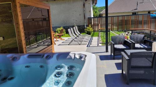 a hot tub on the deck of a house at Somos Lux Vendégház in Somoskőújfalu