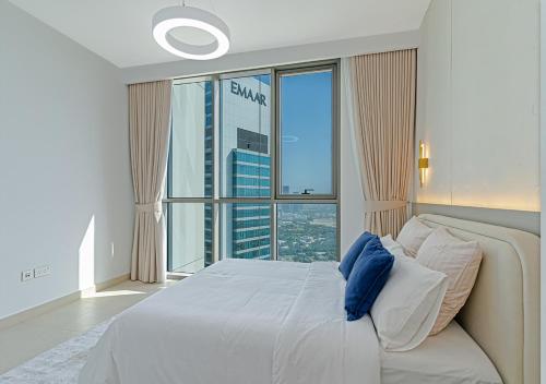 a bedroom with a large bed and a large window at Downtown Views 4702 in Dubai