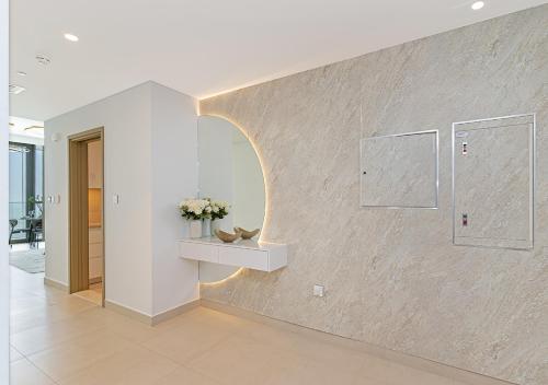 a hallway with a stone wall with a vase of flowers at Downtown Views 4702 in Dubai