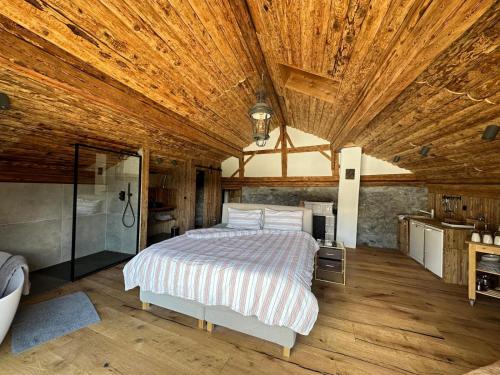 a bedroom with a bed and a wooden ceiling at Chasa Veglia in Sent