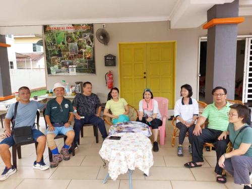 a group of people sitting around a table in a room at Greenleaf Angsana Homestay in Jerantut