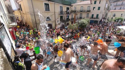 a group of people playing in a fountain in a crowd at A & J in Battipaglia