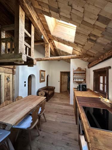 a large room with wooden ceilings and a wooden table at Chasa Veglia in Sent