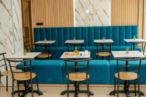 a row of tables and chairs with food on them at Lucky Hotel in Veliko Tŭrnovo