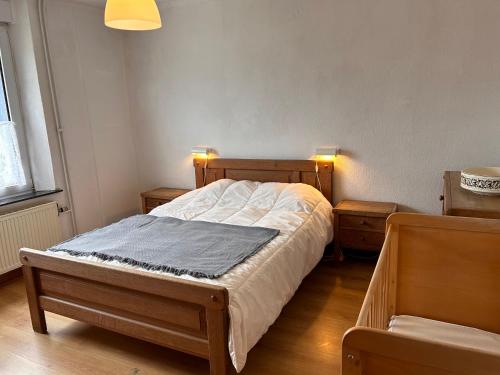 a bedroom with a bed and two night stands at Aux 2 cerisiers in Virton