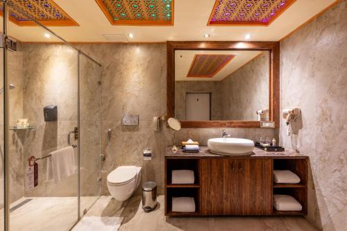 a bathroom with a sink and a shower and a toilet at Chokhi Dhani The Ethnic 5-Star Deluxe Resort in Jaipur