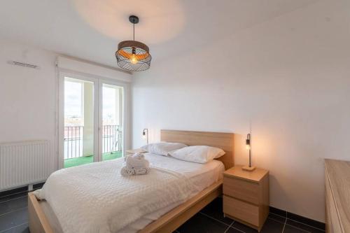 une chambre avec un lit avec un ours en peluche dessus dans l'établissement Location T3 traversant lumineux, à Marseille