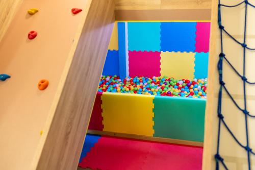 a colorful play room with a wall of balls at Santé SPA Hotel in Velingrad