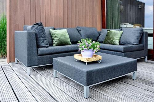 a living room with a couch and a coffee table at Marina VILLA nabij water met prive sauna. in Spakenburg