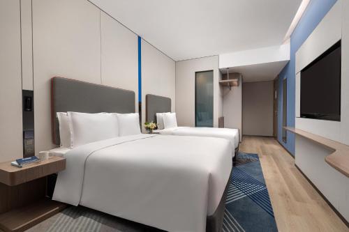 Postel nebo postele na pokoji v ubytování Holiday Inn Express Changfeng Park