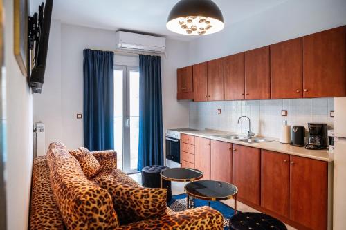 a living room with a couch and a kitchen at LUXURY SUITES - free parking in Drama