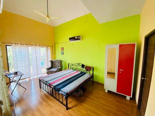 a bedroom with a bed in a room with green at 2BHK Luxurious Villa with Pool in Shenwa