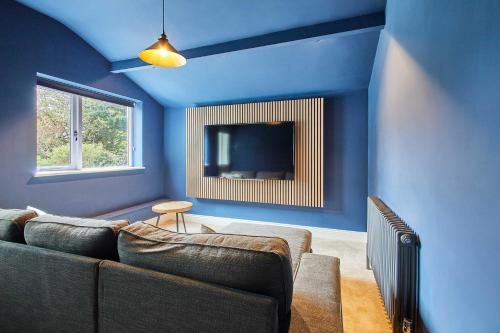 a living room with a couch and a tv at Host & Stay - South View in High Newton