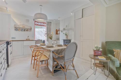 a kitchen and dining room with a table and chairs at Kirrin Cottage- Sheringham -Crabpot Cottages in Sheringham