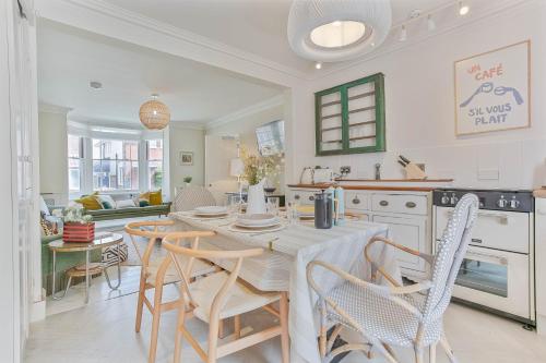 a kitchen and dining room with a table and chairs at Kirrin Cottage- Sheringham -Crabpot Cottages in Sheringham
