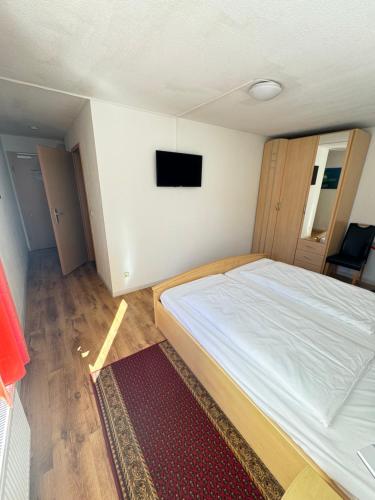 a bedroom with a bed and a television on the wall at Aalreuse in Rostock