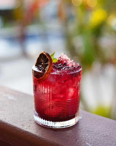 a red drink sitting on top of a table at Pousada do Timoneiro in Arraial do Cabo