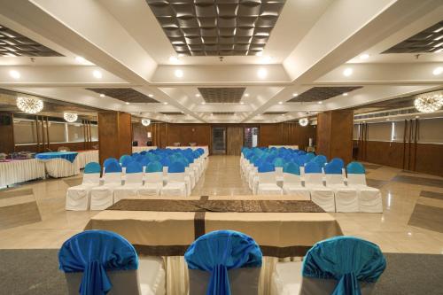 a banquet hall with blue and white tables and chairs at Classic Regency in Alleppey